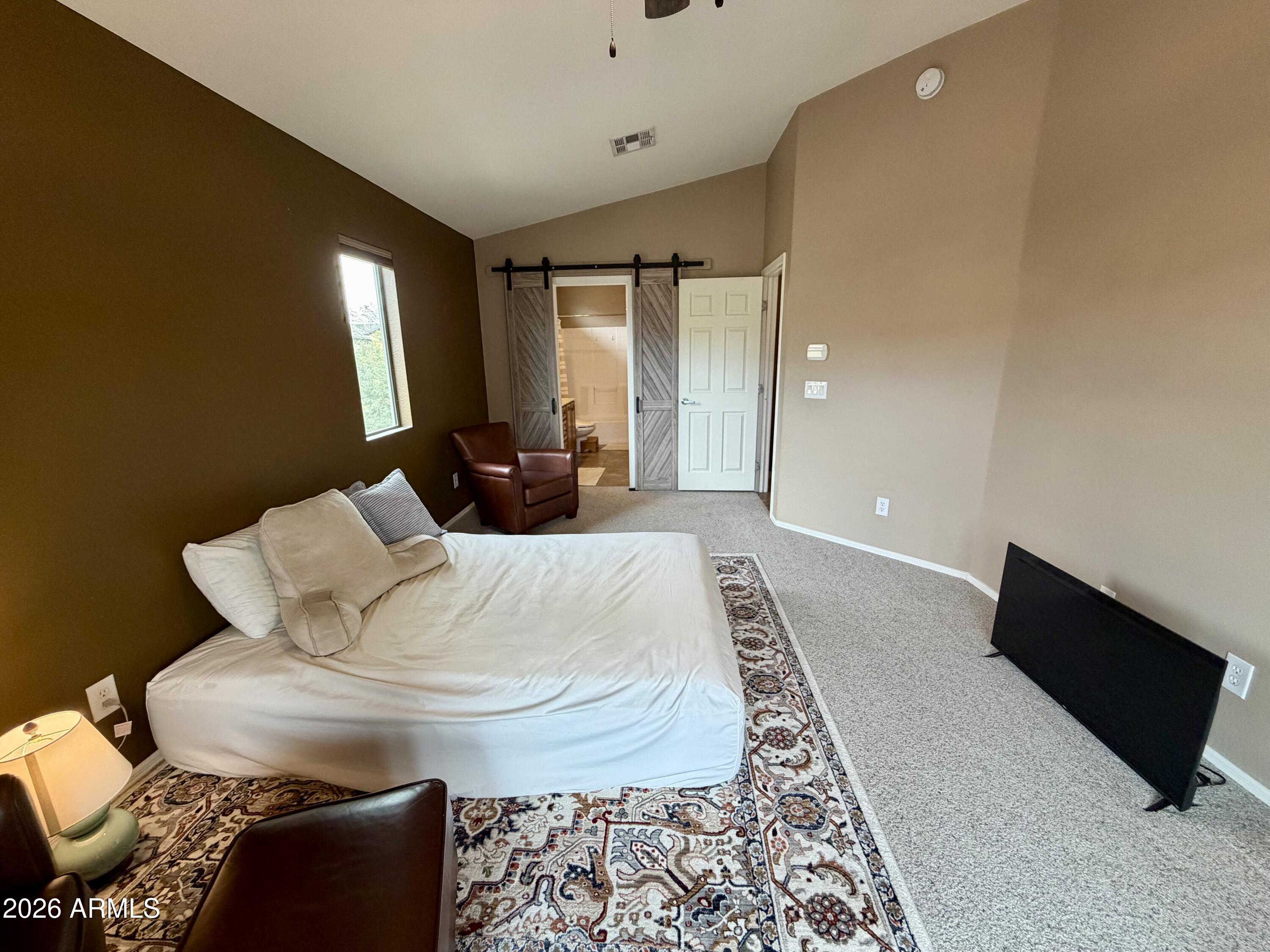 2725 East Mine Creek Road, Unit 2058 Phoenix, AZ 85024 - Photo 8 of 16 a bed sitting in a room next to a window