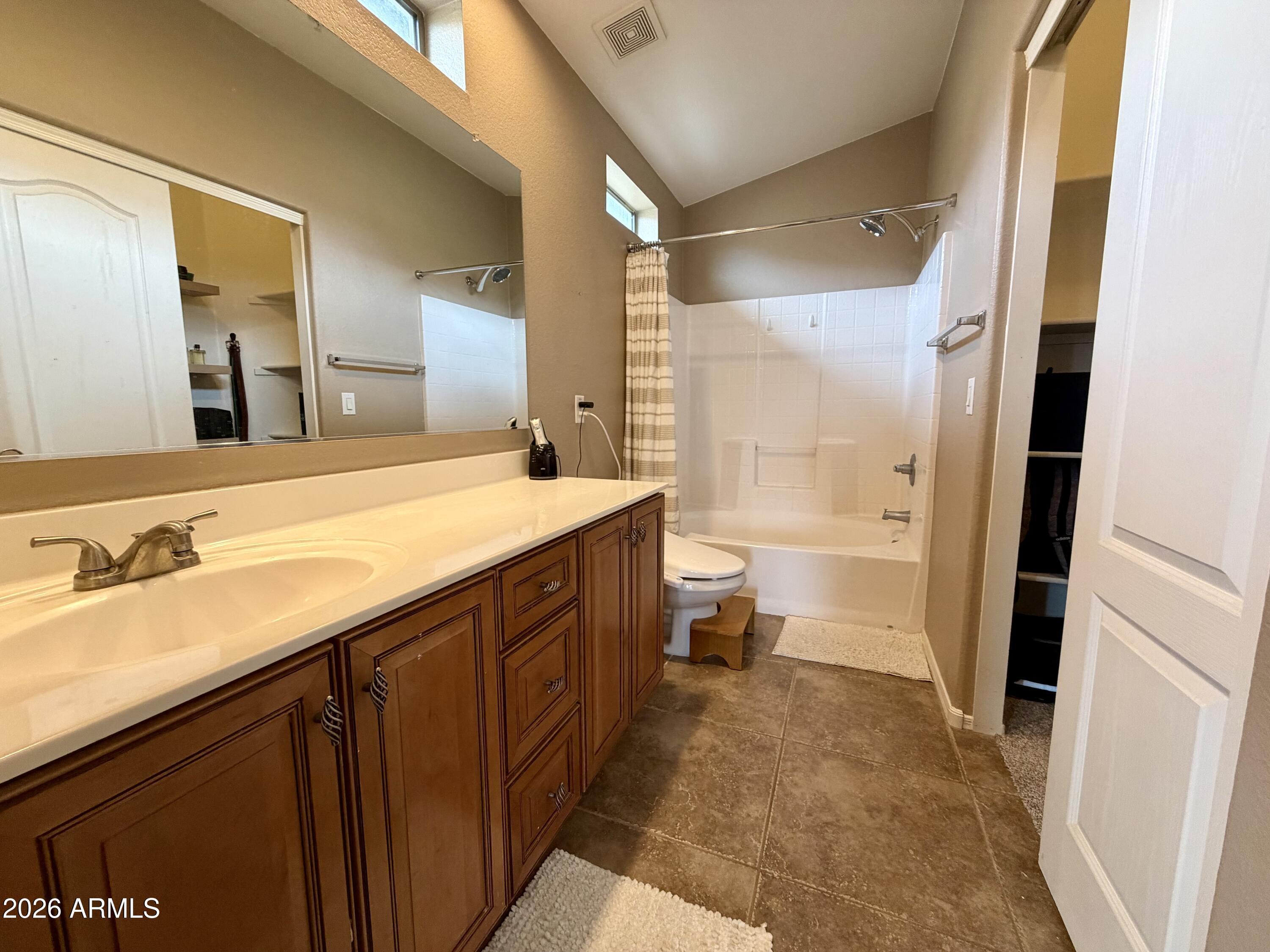 2725 East Mine Creek Road, Unit 2058 Phoenix, AZ 85024 - Photo 9 of 16 a bathroom with a sink a toilet and a large mirror