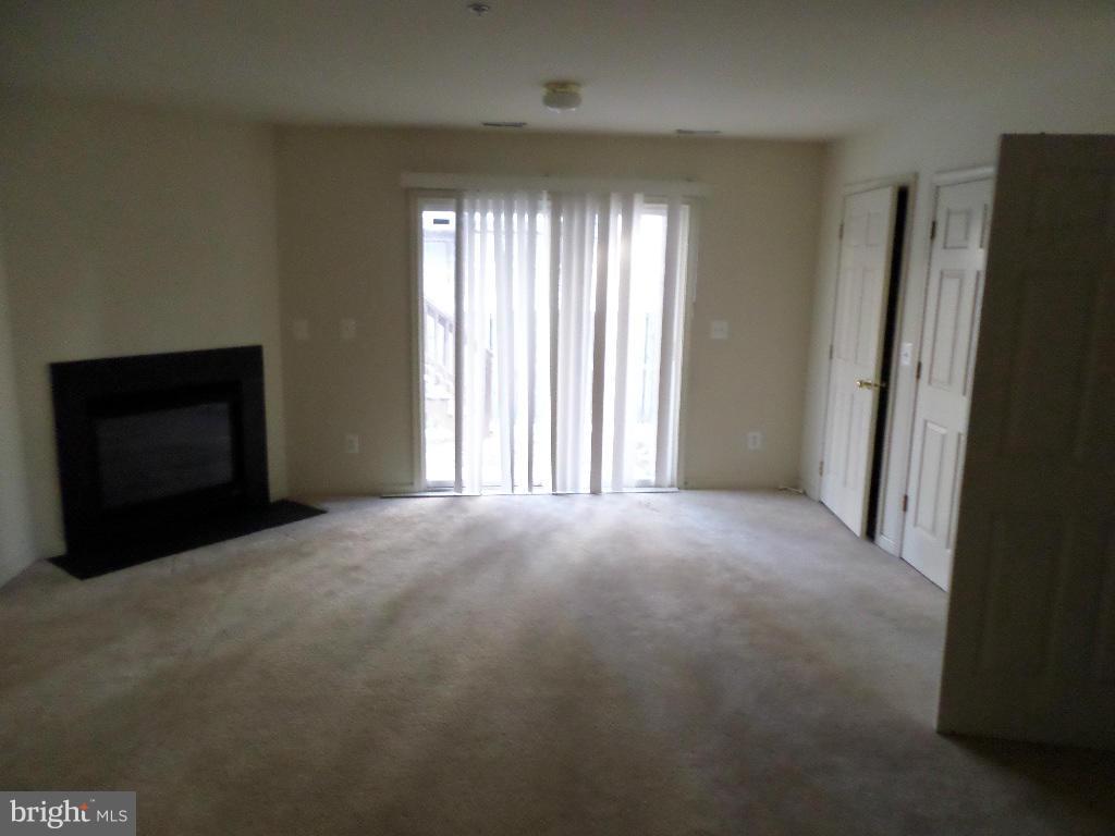 4112 Cutty Sark Road Baltimore, MD 21220 - Photo 14 of 16 a view of empty room with windows and fireplace