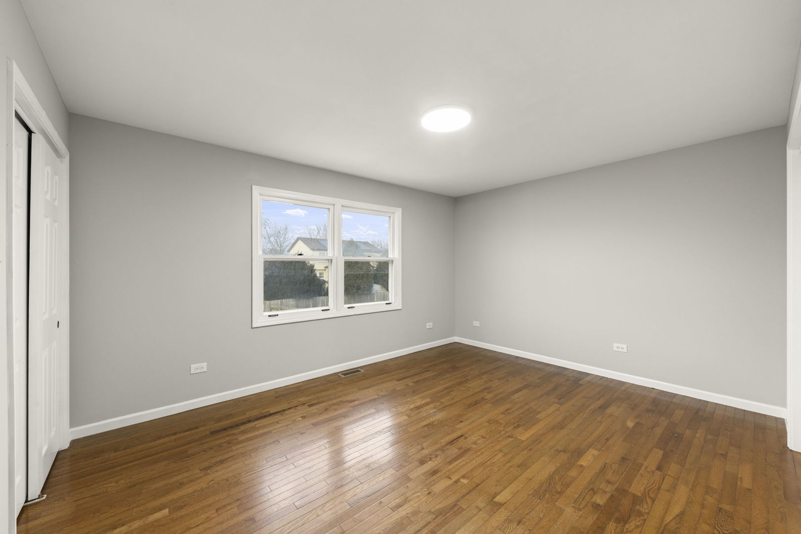 6605 Klinger Lane Plainfield, IL 60586 - Photo 11 of 21 a view of an empty room with wooden floor and a window
