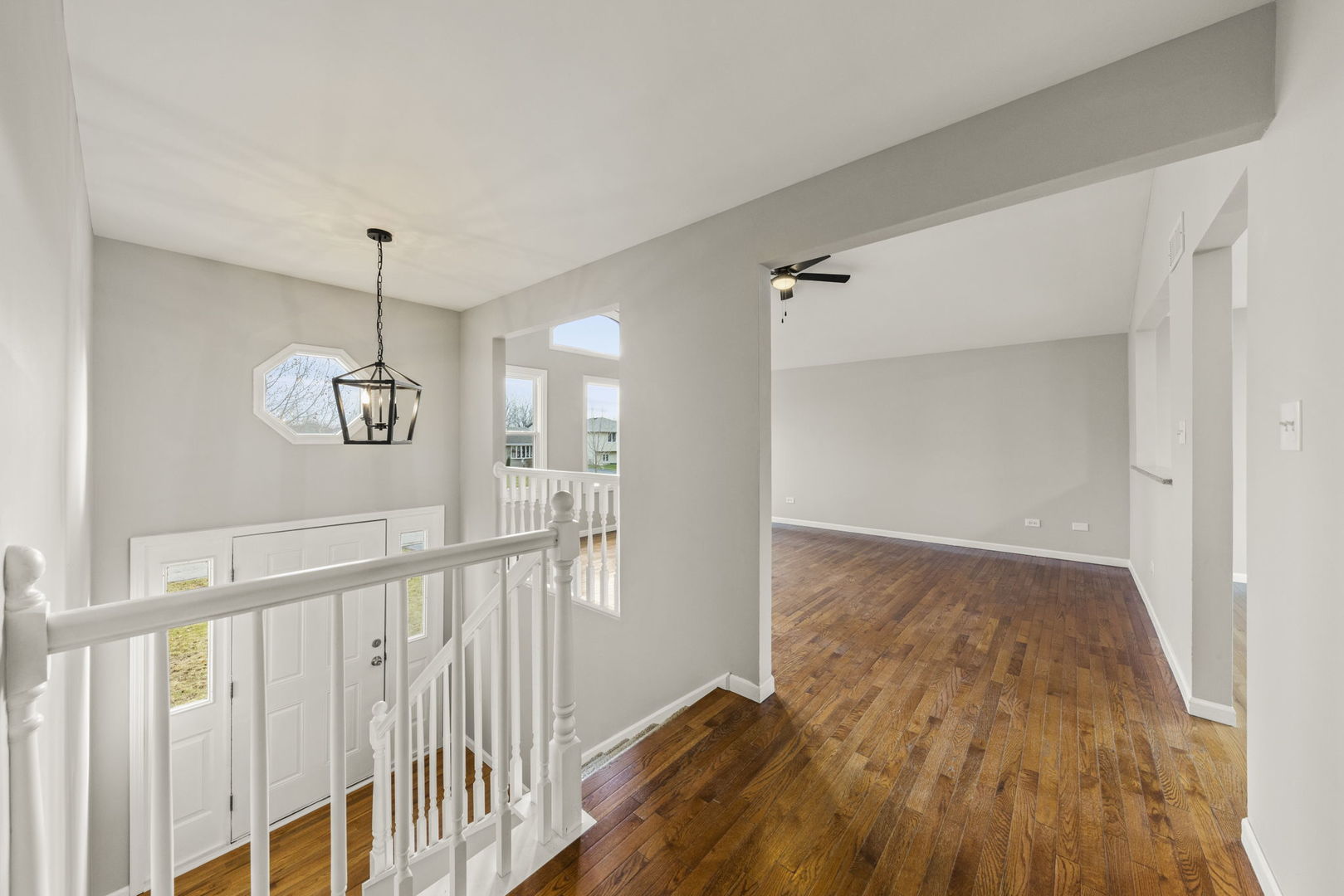 6605 Klinger Lane Plainfield, IL 60586 - Photo 2 of 21 a view of a hallway view with wooden floor and staircase