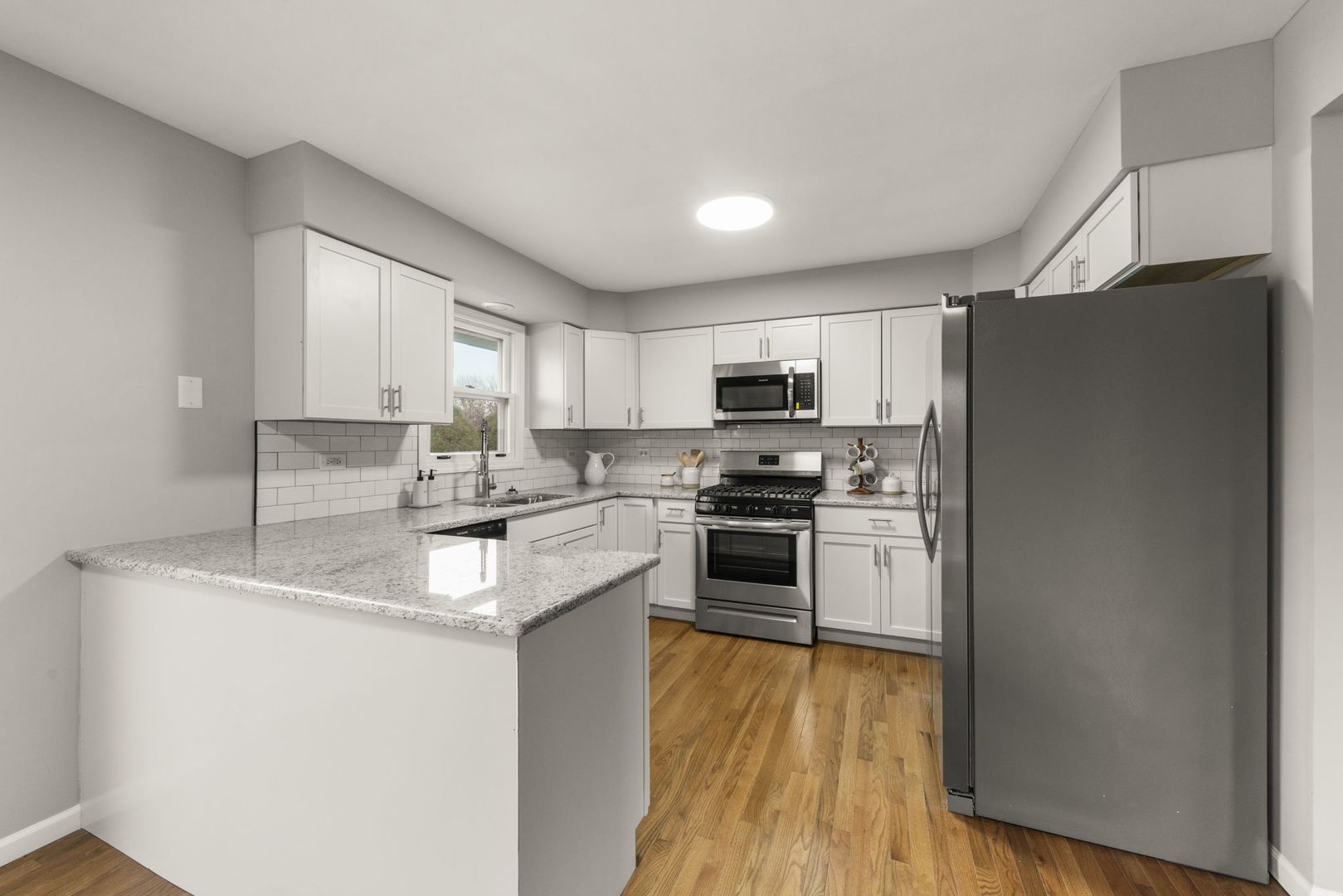 6605 Klinger Lane Plainfield, IL 60586 - Photo 4 of 21 a kitchen with a refrigerator sink and cabinets
