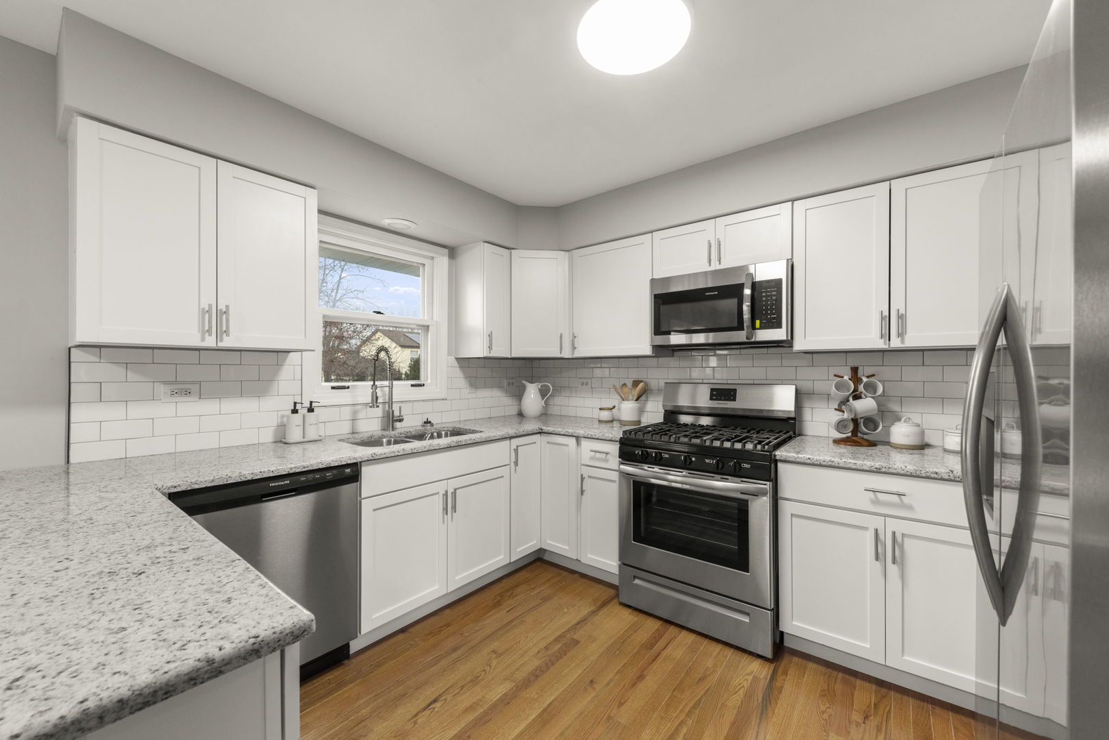 6605 Klinger Lane Plainfield, IL 60586 - Photo 5 of 21 a kitchen with stainless steel appliances granite countertop a sink and stove top oven