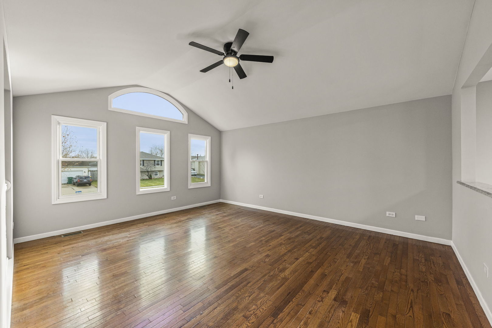 6605 Klinger Lane Plainfield, IL 60586 - Photo 8 of 21 an empty room with wooden floor fan and windows