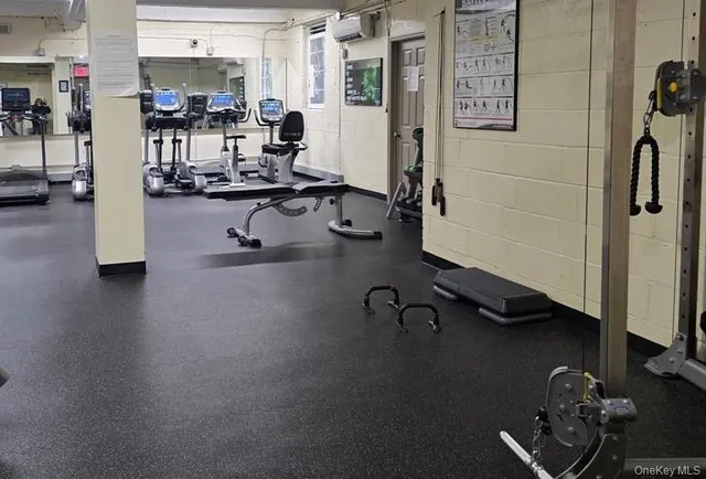 a room with gym equipment and a large window