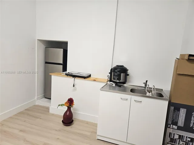 a kitchen with a sink and a refrigerator