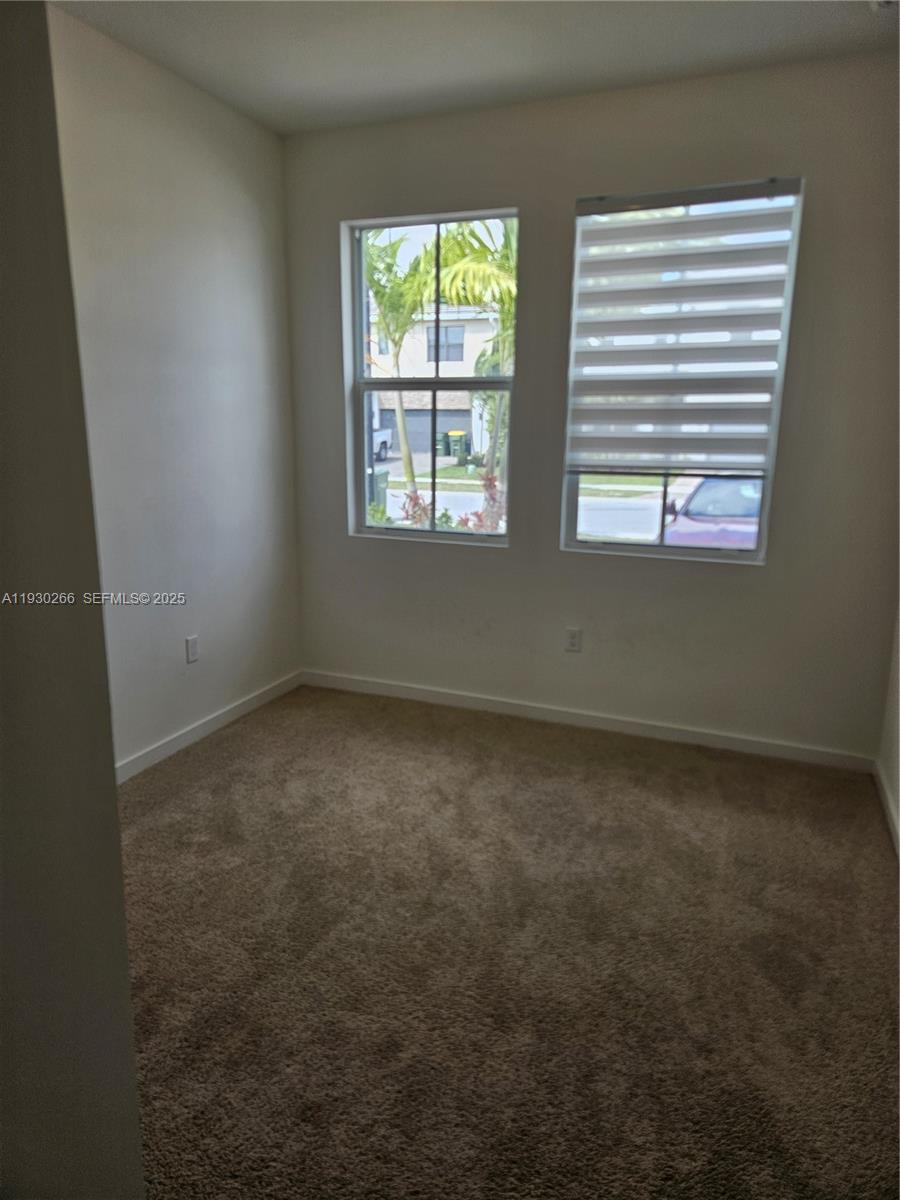 157 Northeast 13th Street Homestead, FL 33030 - Photo 7 of 10 an empty room with a window