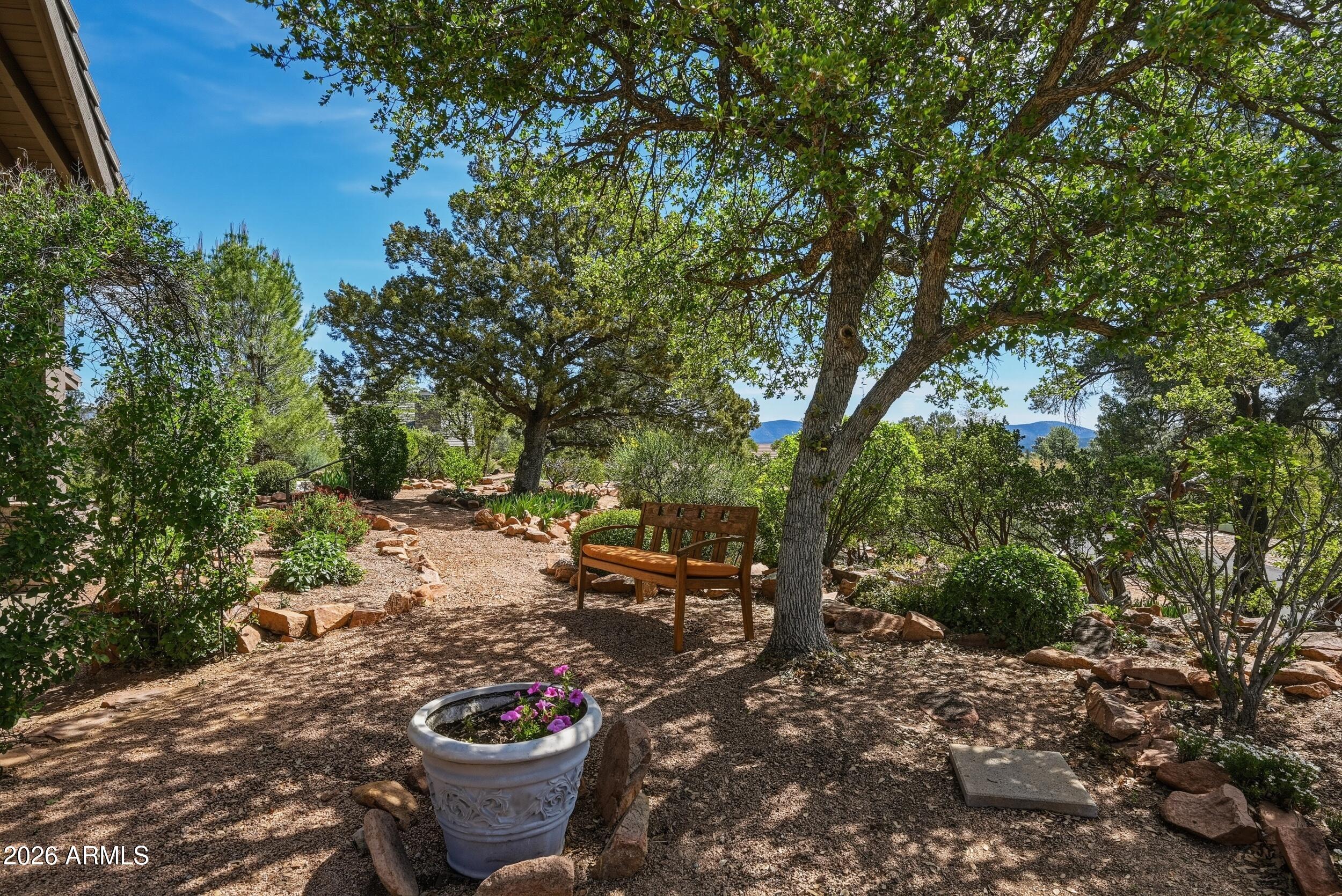3101 East Mayfield Payson, AZ 85541 - Photo 11 of 71 a view of a backyard with table and chairs potted plants and large trees