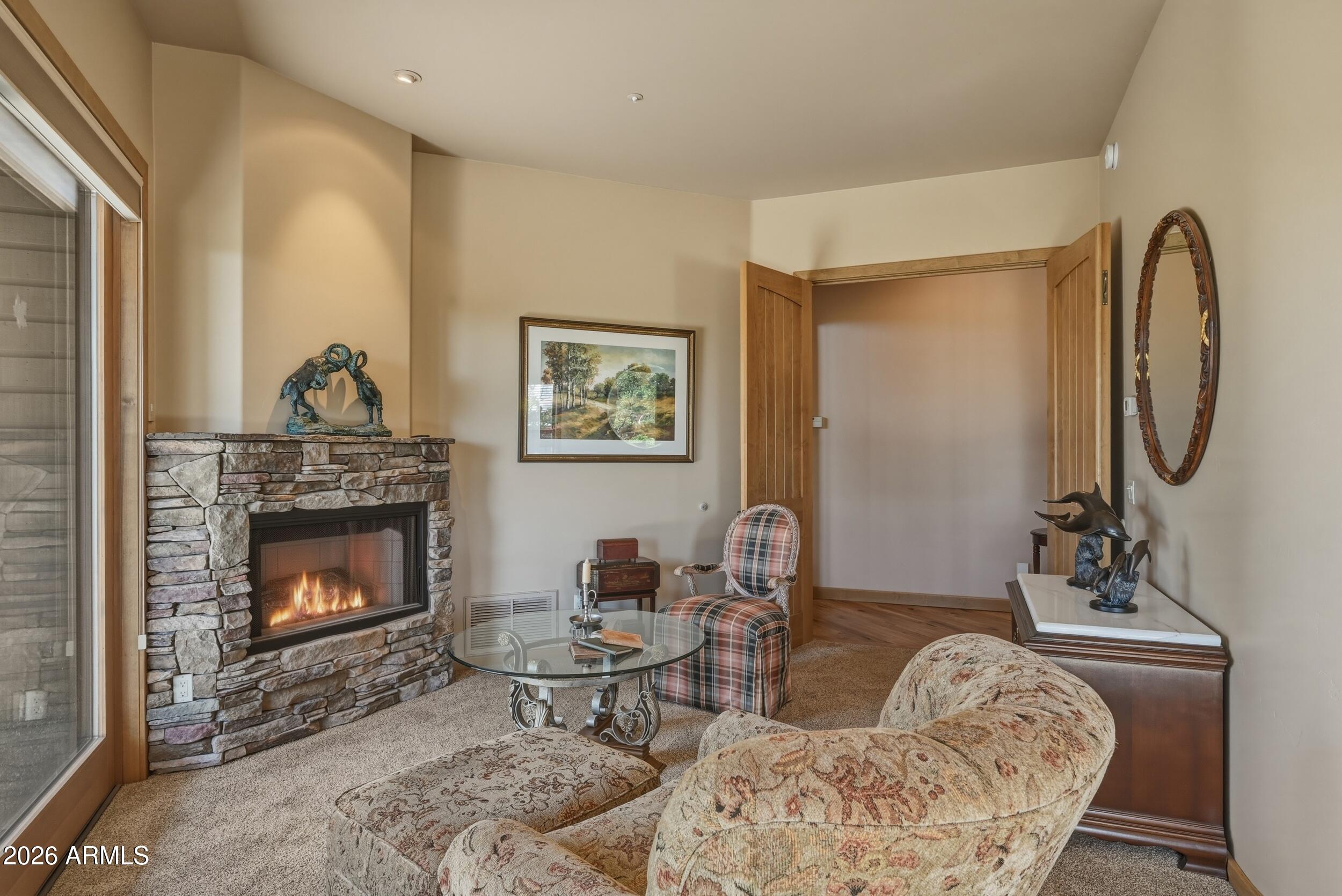 3101 East Mayfield Payson, AZ 85541 - Photo 28 of 71 a living room with furniture a table and a fireplace