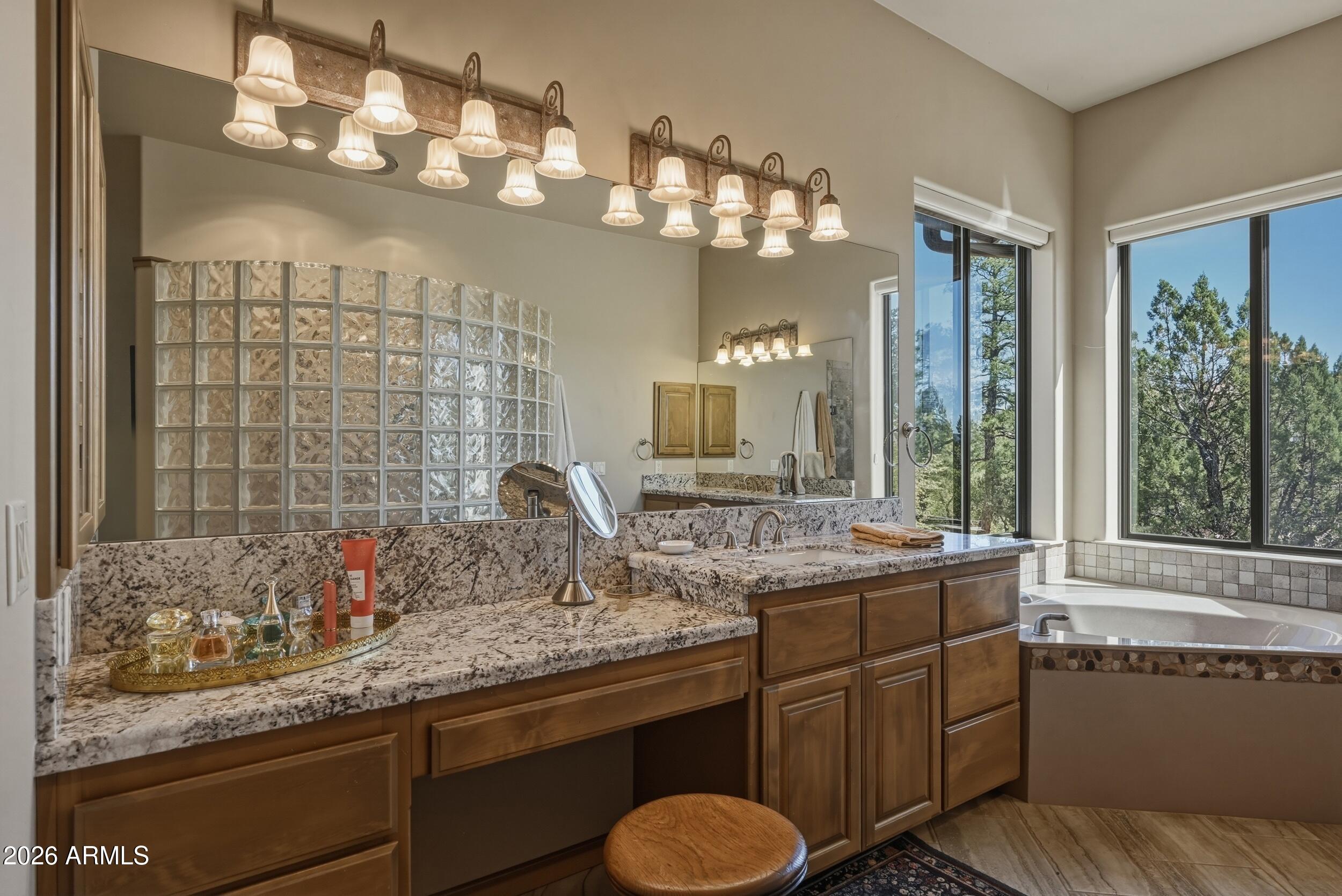 3101 East Mayfield Payson, AZ 85541 - Photo 30 of 71 a bathroom with a granite countertop sink a large mirror and a bathtub