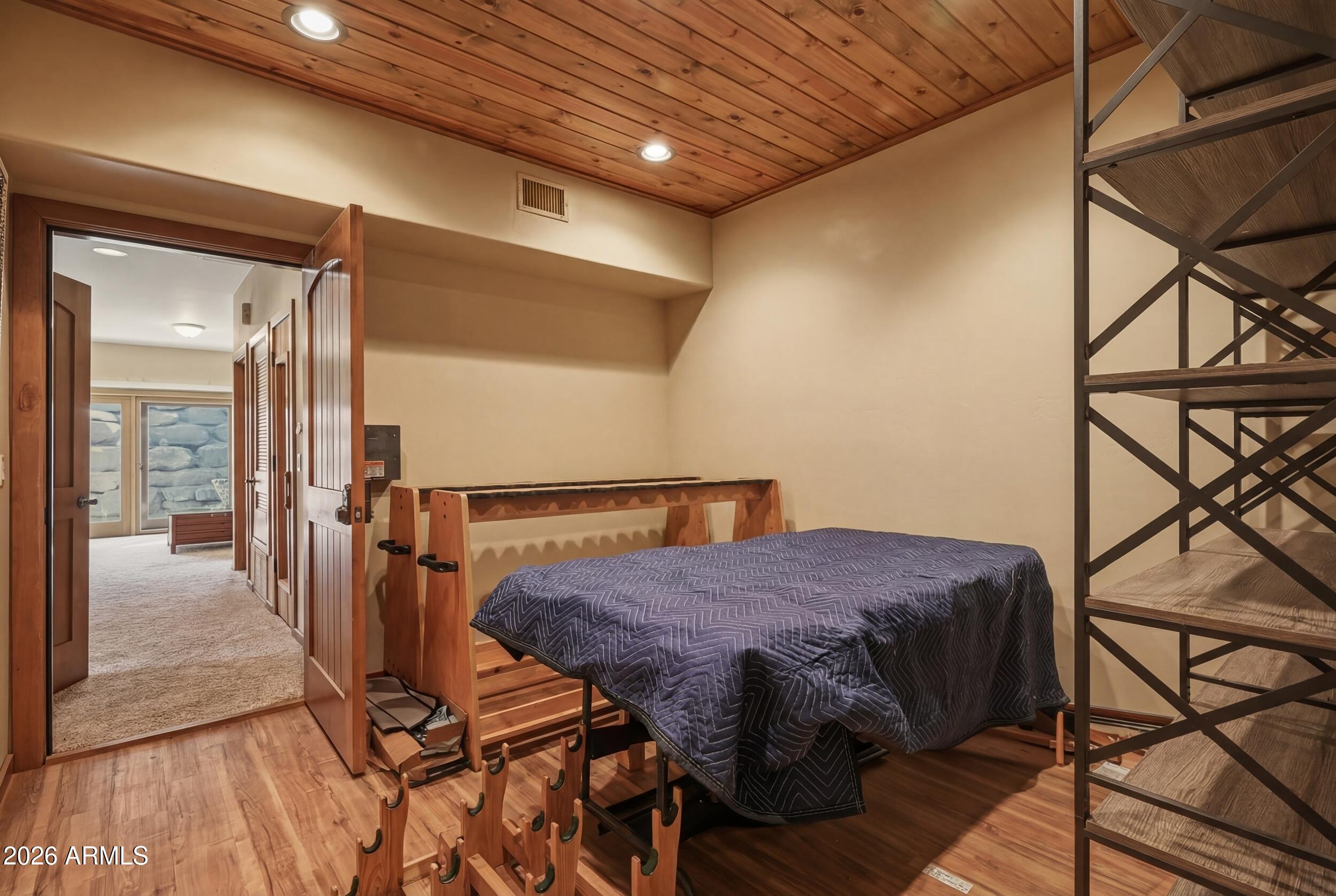 3101 East Mayfield Payson, AZ 85541 - Photo 55 of 71 a bedroom with a bed and wooden floor