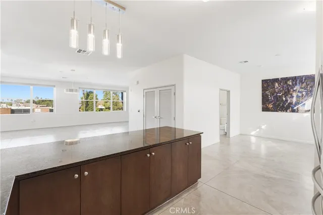a kitchen with kitchen island a counter top space a sink and chandelier