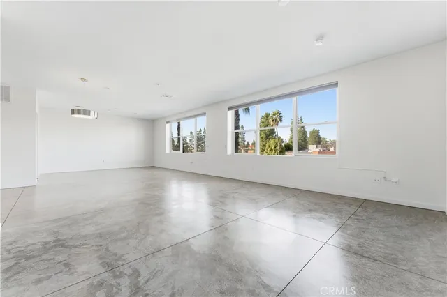 a view of a kitchen with a refrigerator and a sink