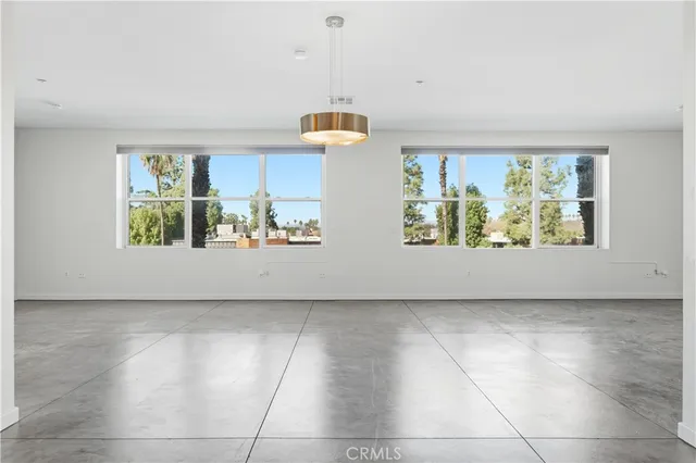 an empty room with a kitchen and a sink