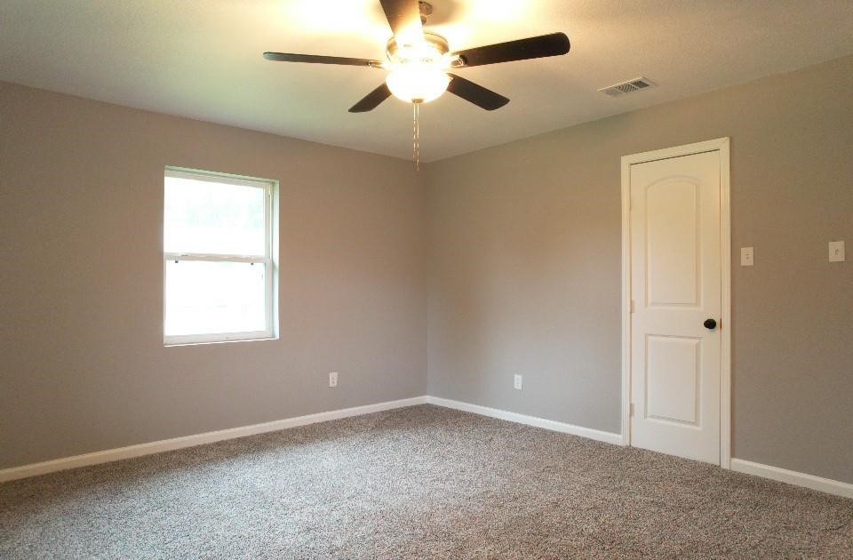 25373 Goodson Road Splendora, TX 77372 - Photo 17 of 41 an empty room with a window and a fan