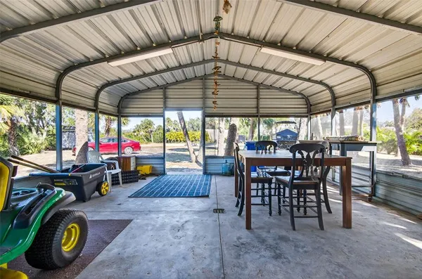 a view of a chairs and table in patio