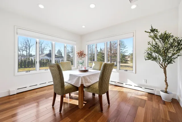 a view of a dining room with furniture window and wooden floor
