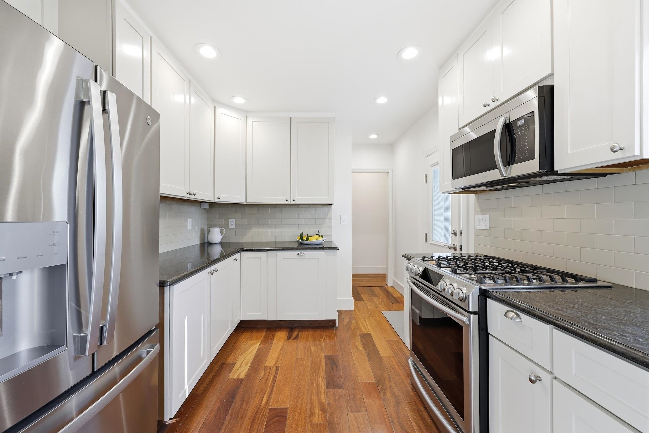 862 Central Hammonton, NJ 08037 - Photo 20 of 46 a kitchen with stainless steel appliances a sink dishwasher a refrigerator and cabinets with wooden floor
