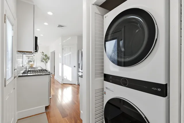 a view of a hallway with washer and dryer