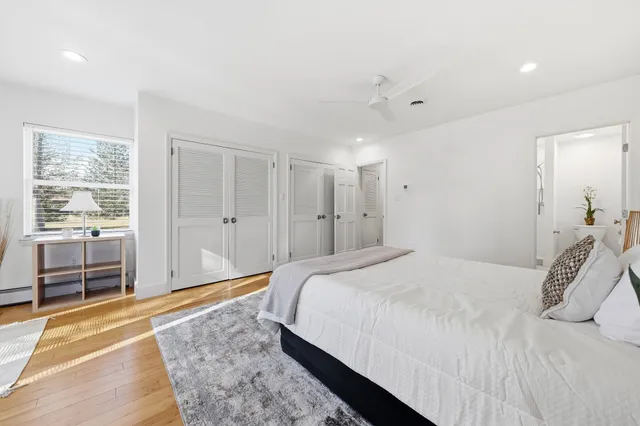 a spacious bedroom with a bed and glass door