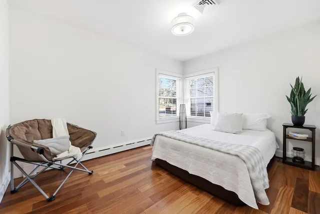 a bedroom with a bed and chair