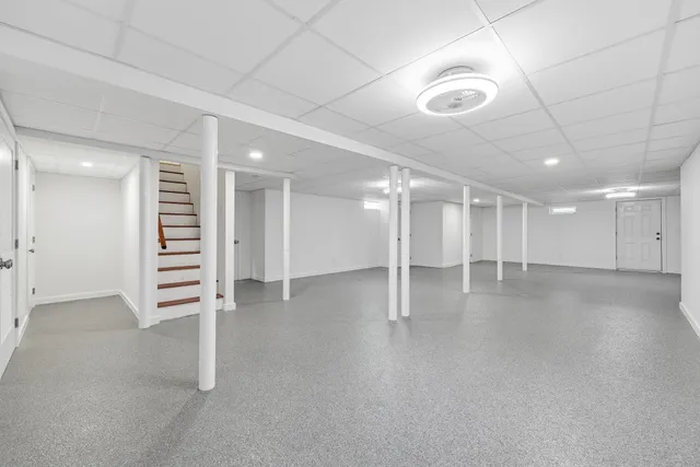 an empty room with a ceiling fan and natural light