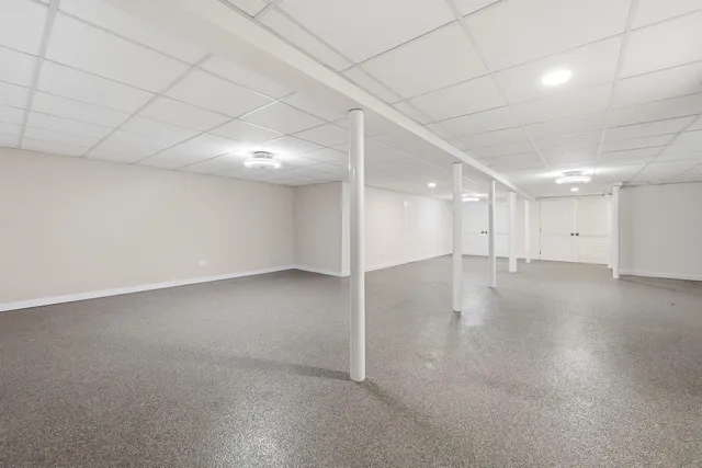 an empty room with a empty space and windows