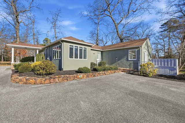 a front view of a house with a garden