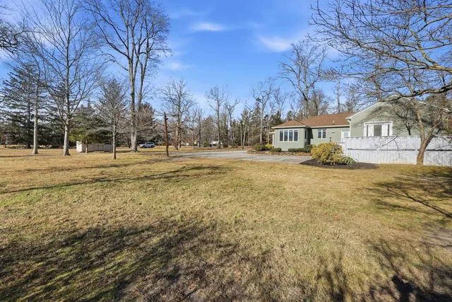 a backyard of apartments with large trees
