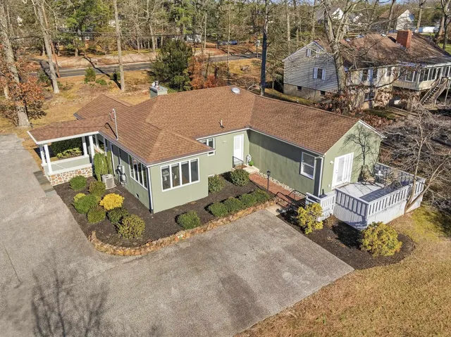 an aerial view of a house with a yard
