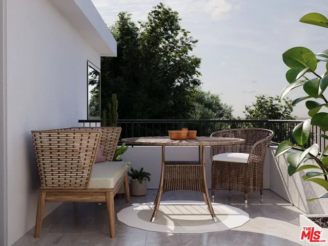 a outdoor space with a couch and chairs