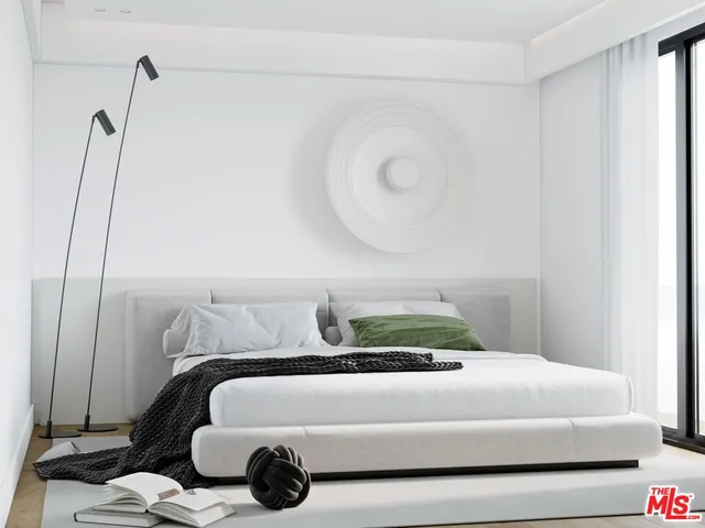 a bedroom with a bed and a mirror