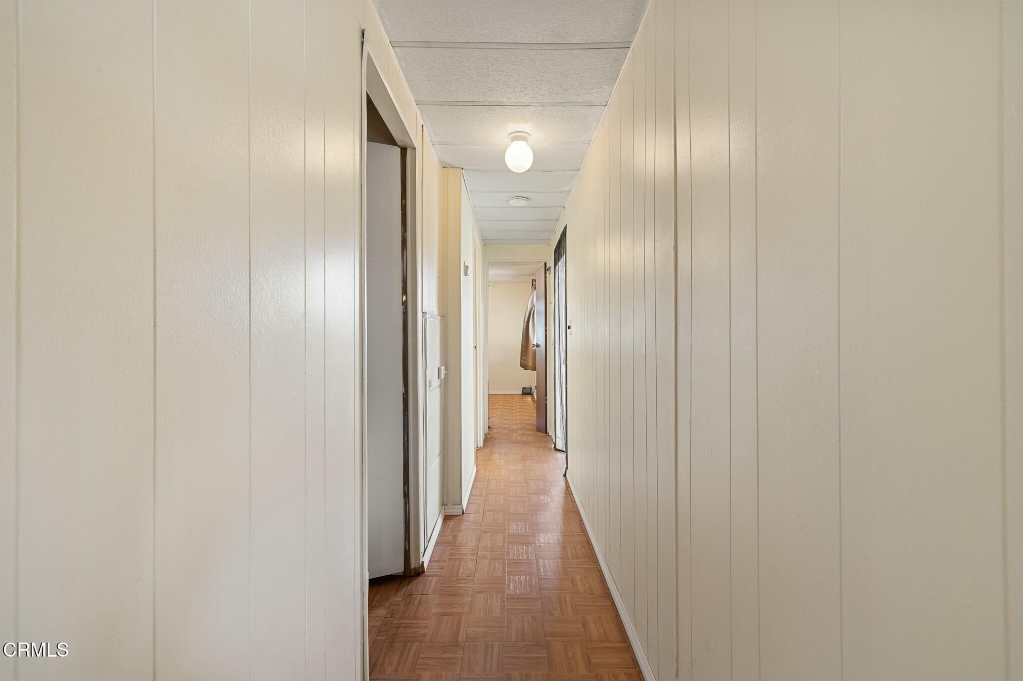 1853 Ives Avenue, Unit 51 Oxnard, CA 93033 - Photo 17 of 38 a view of a hallway with wooden floor