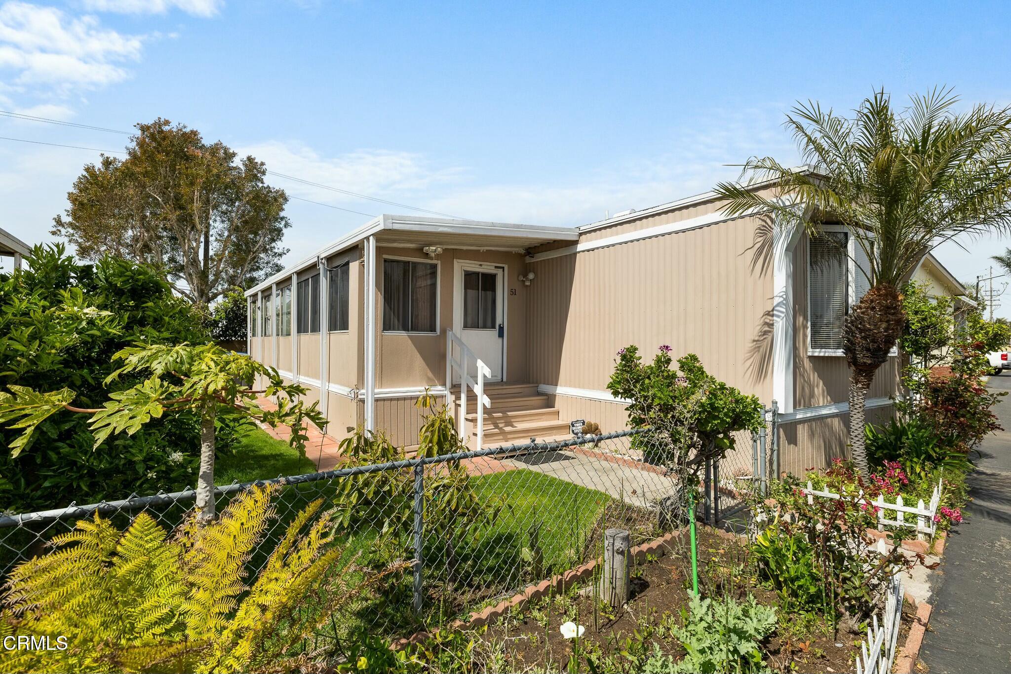 1853 Ives Avenue, Unit 51 Oxnard, CA 93033 - Photo 5 of 38 a view of a house with a yard and garden