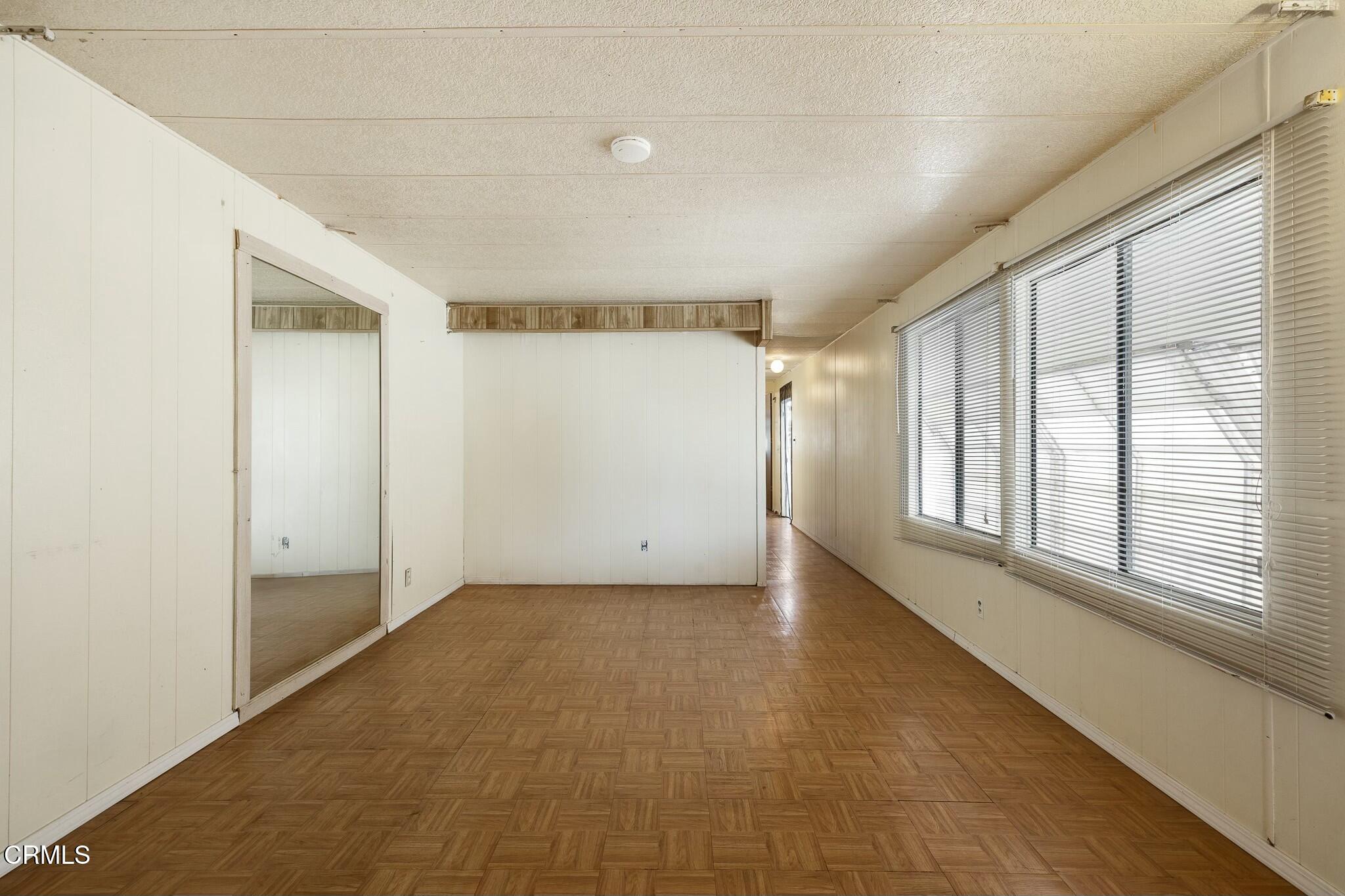 1853 Ives Avenue, Unit 51 Oxnard, CA 93033 - Photo 9 of 38 a view of an empty room with a window