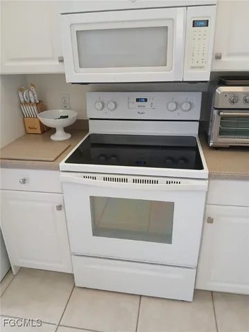 a stove top oven sitting inside of a kitchen