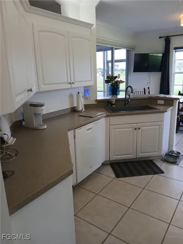 a kitchen with a sink cabinets and window