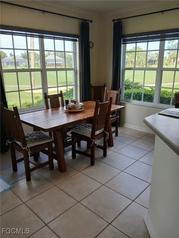a view of a dining room with furniture and window