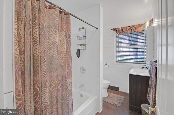 a bedroom with a bed and a ceiling fan