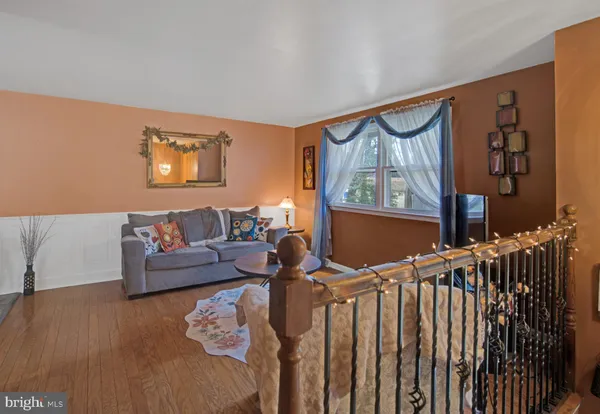 a living room with furniture and a painting on the wall