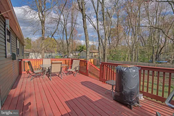 a balcony with wooden floor and outdoor seating