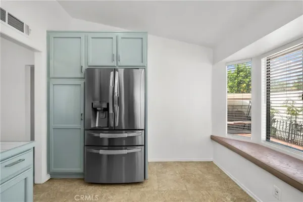 a kitchen with a refrigerator and microwave