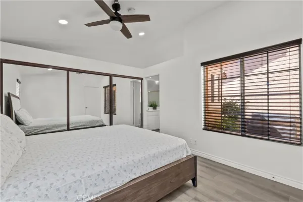 a bedroom with a large bed and a window