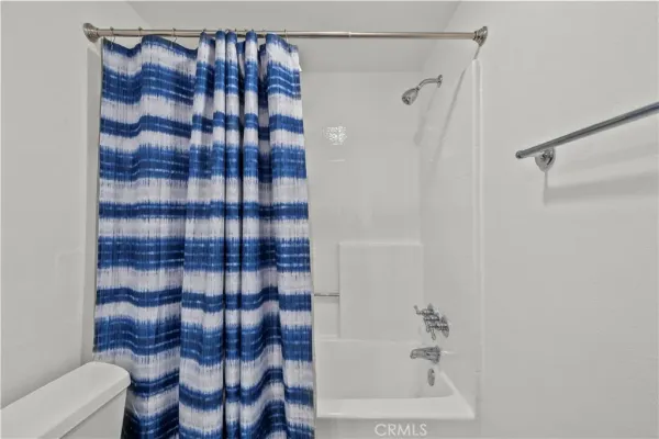 a bathroom with a shower and a toilet