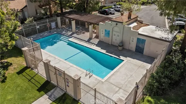 a view of a white house with a swimming pool