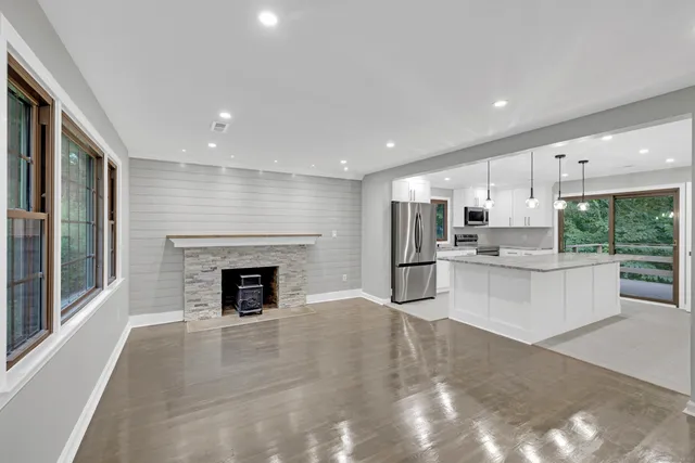 a view of kitchen with granite countertop lots of counter top space and stainless steel appliances