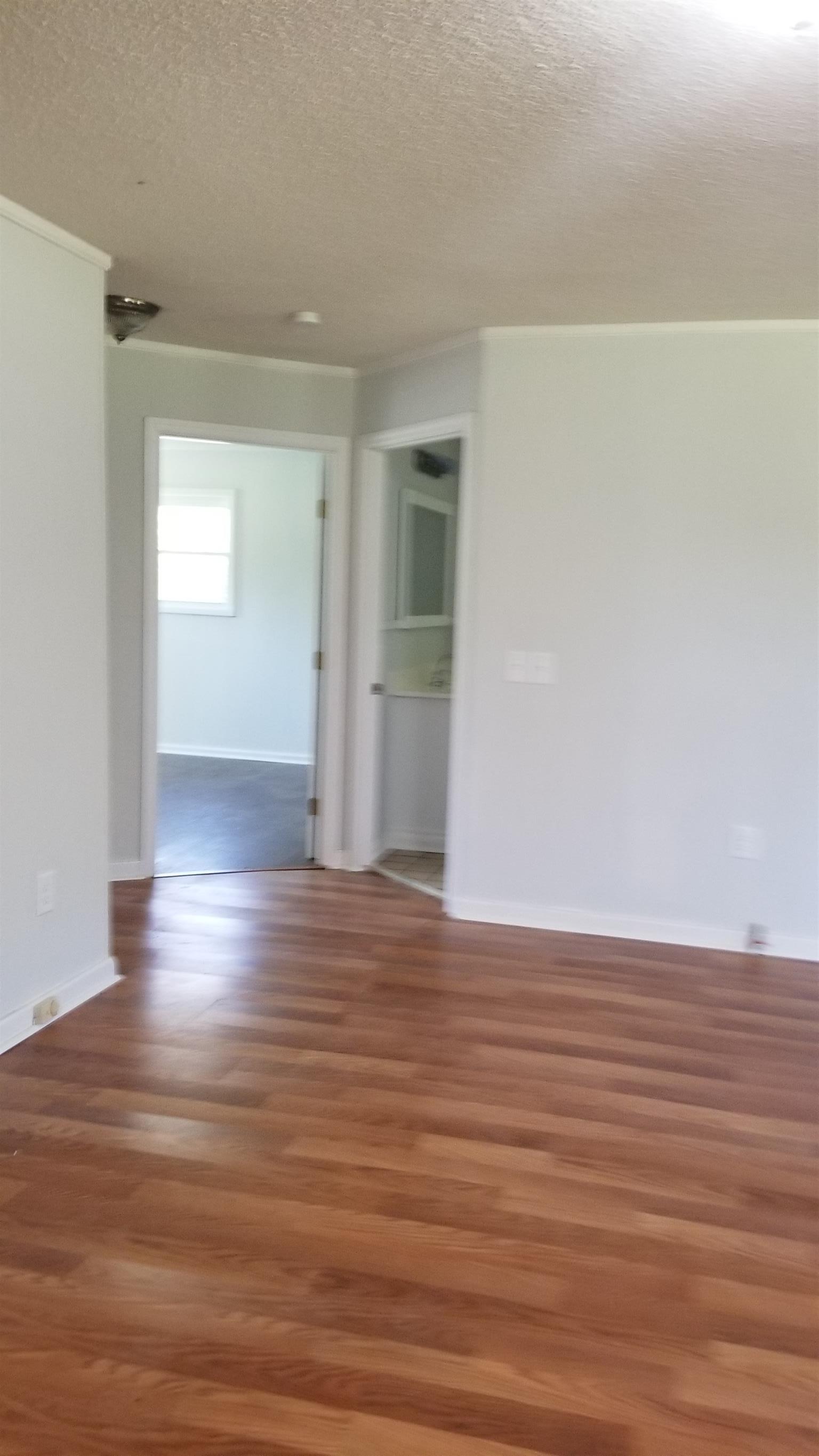 97 Hughes Road Westpoint, TN 38486 - Photo 10 of 18 a view of an empty room with wooden floor and a window