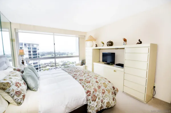 a bedroom with a bed and a flat screen tv