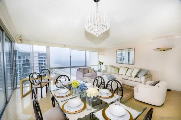 a view of a dining room with furniture a chandelier and wooden floor