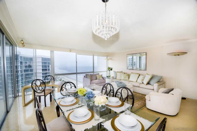 a view of a dining room with furniture a chandelier and wooden floor